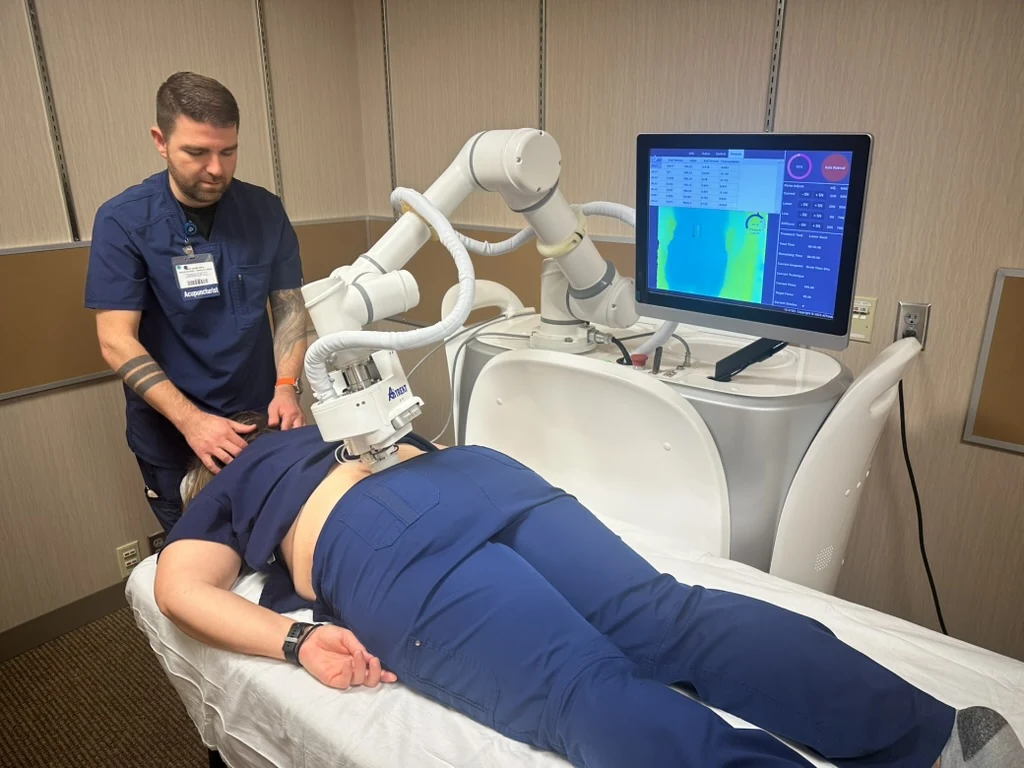 Practitioner supervising an EMMA treatment session